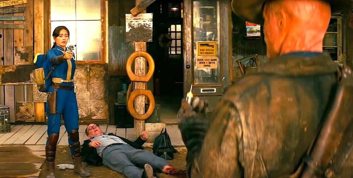 Два круглых гаджета в центре скриншота под плакатом "Мы торгуем только за КРЫШКИ" - видимо, это утонченная постапокалиптическая шутка (крышки БУТЫЛОЧНЫЕ - местная валюта). 