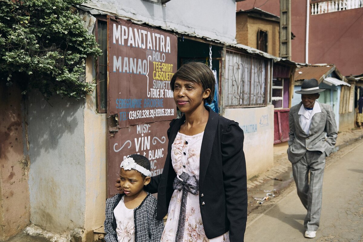 Фара Рафаранириана идет в церковь воскресным утром со своей дочерью Одлиатемикс и отцом Дада Полом в Антананариву, Мадагаскар.