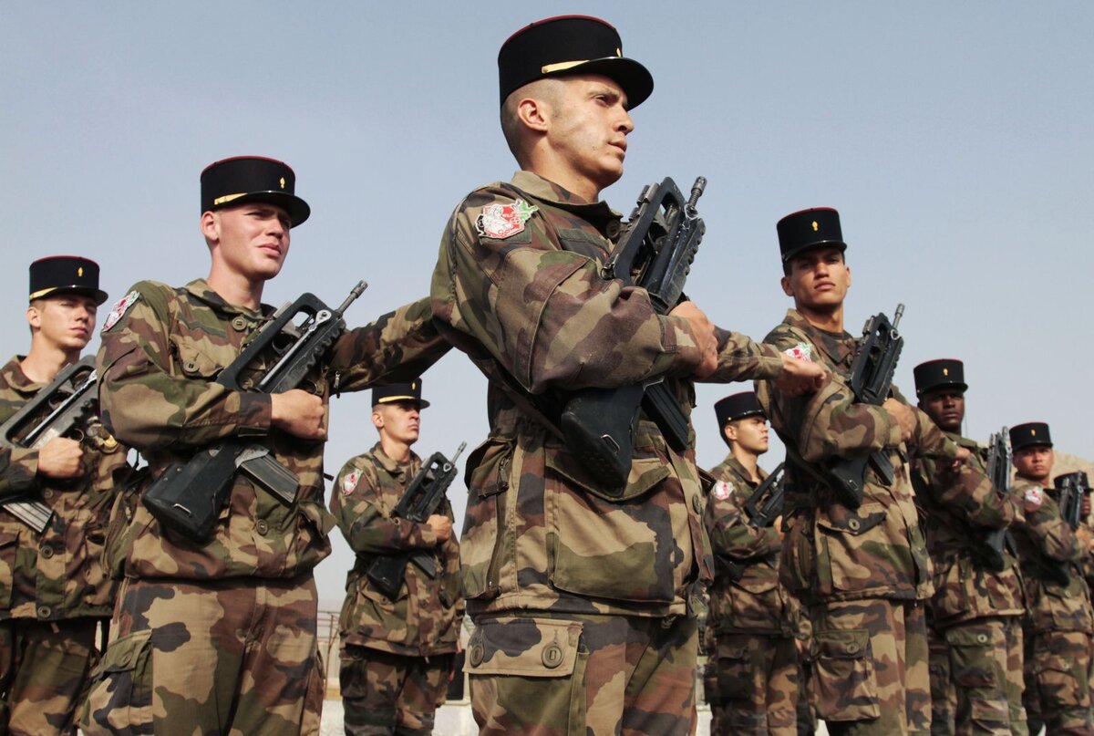    French soldiers make a transfer during an authority ceremony from the French soldiers to Afghan security forces in Surobi, east of Kabul, Afghanistan, Tuesday, July 31, 2012. French troops have handed over one of their bases near Kabul to the Afghan army as part of the pullout of 2,000 French combat soldiers by year's end. Tuesday's handover of the forward operating base in the restive Surobi district about 50 kilometers (30 miles) from central Kabul was marked by a ceremony. The French flag was lowered and the Afghan one hoisted in its place. (AP Photo/Musadeq Sadeq) editor