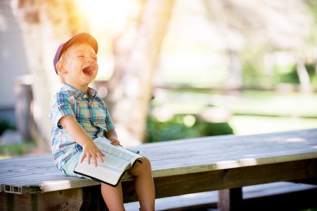 https://unsplash.com/photos/boy-sitting-on-bench-while-holding-a-book-4K2lIP0zc_k