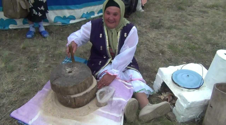 Перемалывание крупы на деревянном жёрнове. Фото из открытых источников.