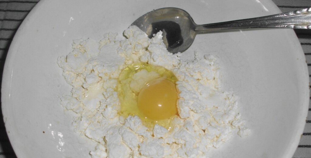 Творог и разбитое сырое яйцо в белой миске. Личное фото автора канала Житейская проза