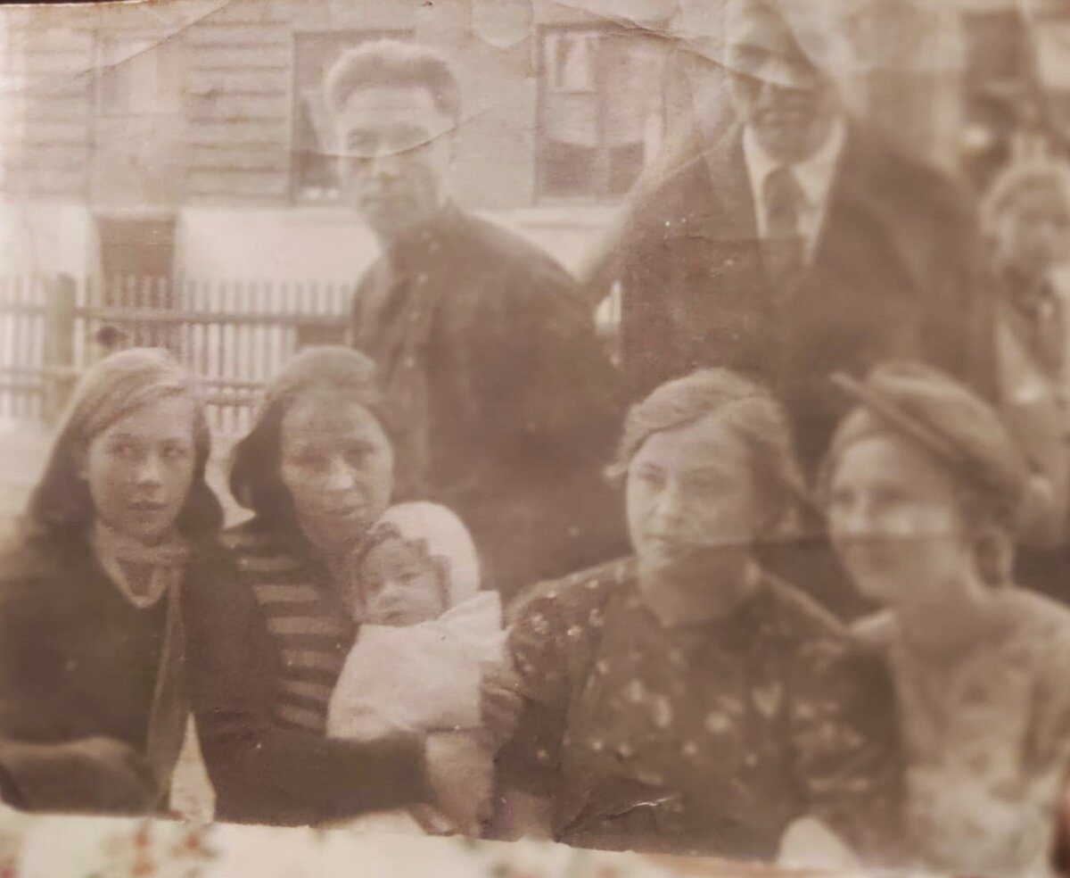 Довоенное фото в нашем дворе. Слева моя тётя Оля, бабушка с новорождённым сыном, сзади мой дедушка Порфирий Степанович и соседи по дому. 
