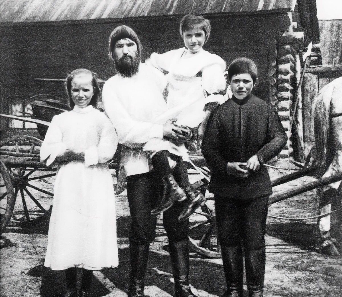 Дочь Матрена, Григорий Распутин, на руках — дочь Варвара, справа сын Дмитрий. Село Покровское, 1914 