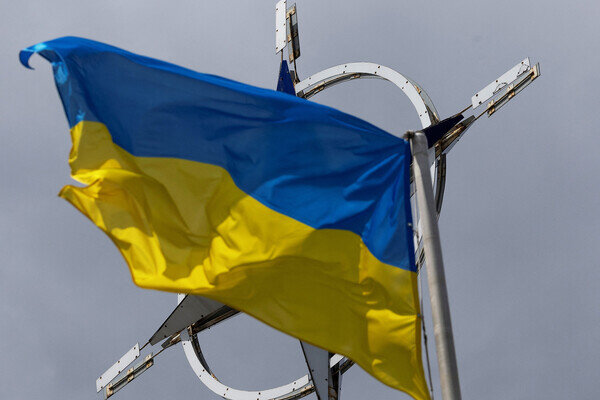 A Ukrainian national flag rises in front of the NATO emblem, amid Russia's attack on Ukraine, in central Kyiv, Ukraine July 11, 2023. REUTERS/Valentyn Ogirenko / Valentyn Ogirenko/Reuters 