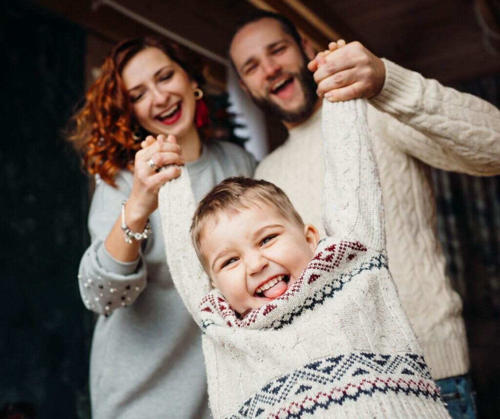 The mother and father playing with their son