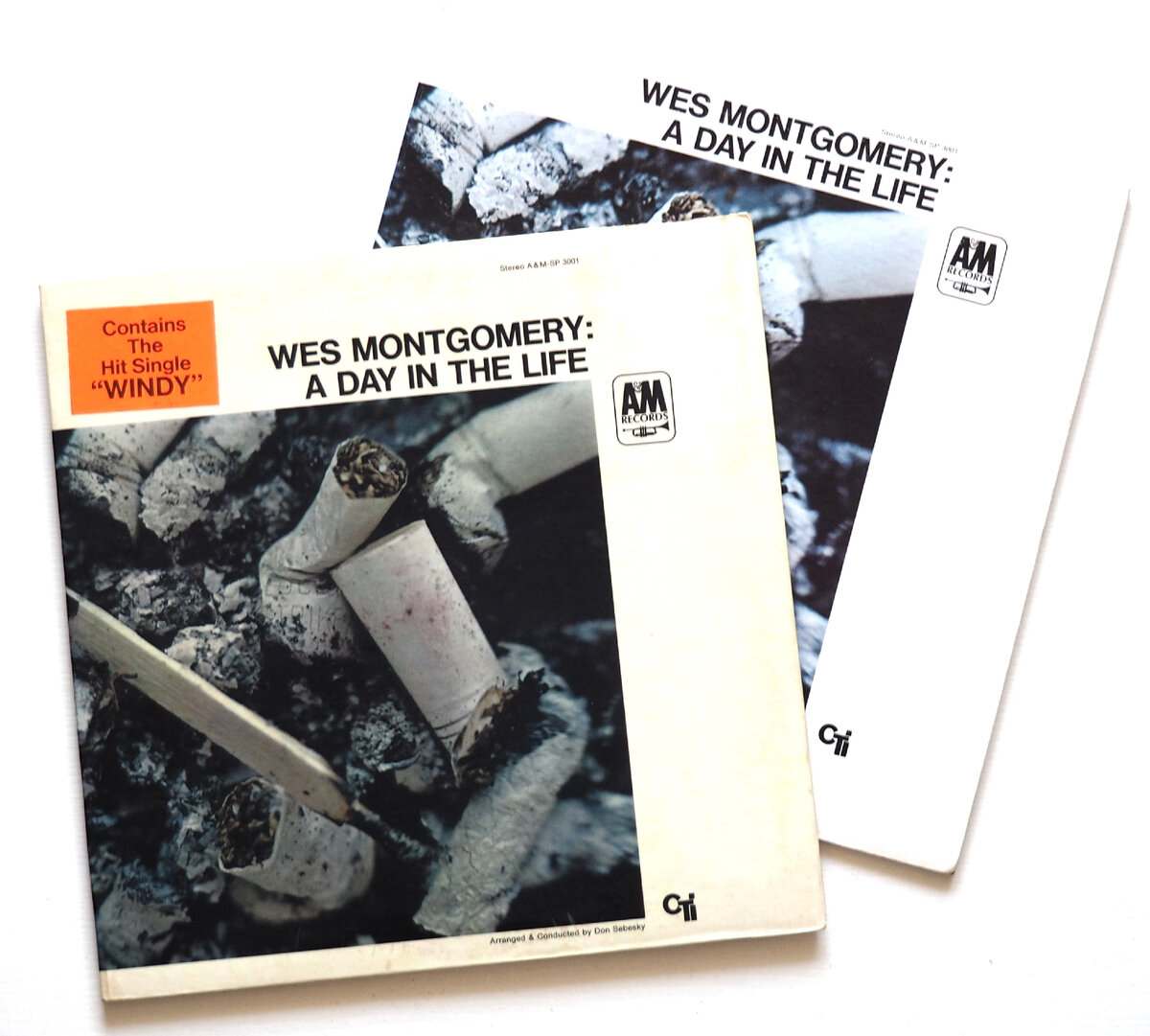 Первой полноценной пластинкой CTI (до этого был сэмплер, рассказывавший о стартовых релизах лейбла) стал альбом гитариста Уэса Монтгомери 'A Day In The Life' - на фото слева оригинальное издание, справа переиздание конца семидесятых. На конверт оригинала наклеен стикер с напоминанием о присутствии на пластинке популярной версии мелодии 'Windy'. 