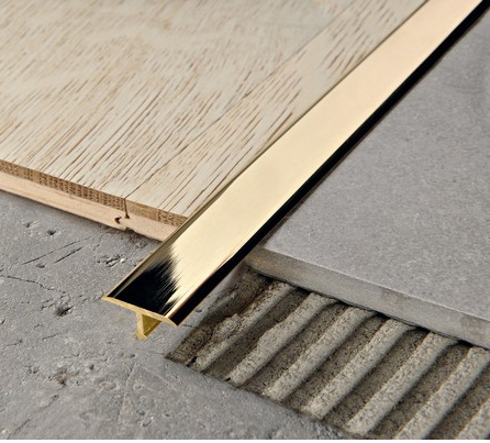 Стыковка плитки и ламината Т-образным профилем под золото