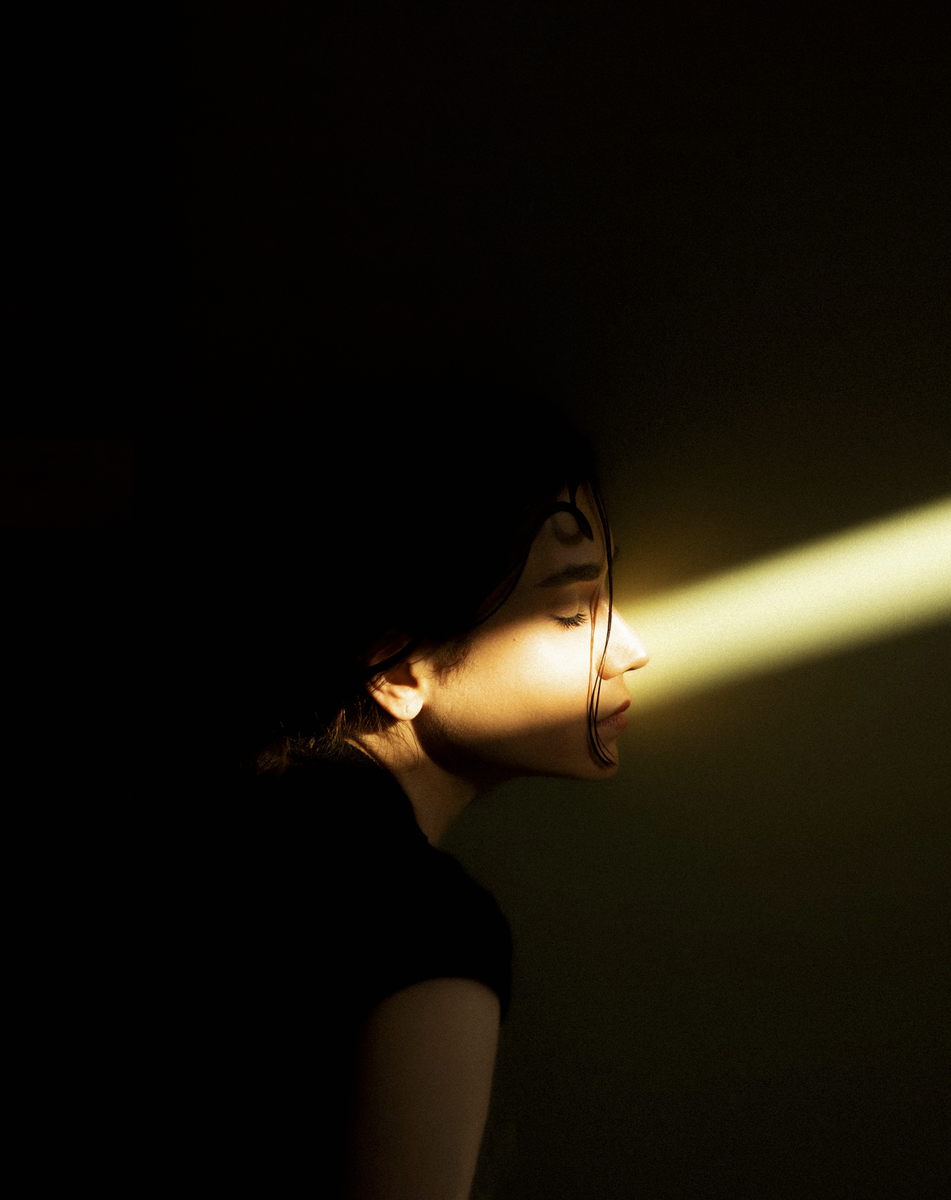 Ajnj https://unsplash.com/photos/a-woman-standing-in-a-dark-room-with-a-light-coming-through-her-eyes-EcdtLQW8JiI
