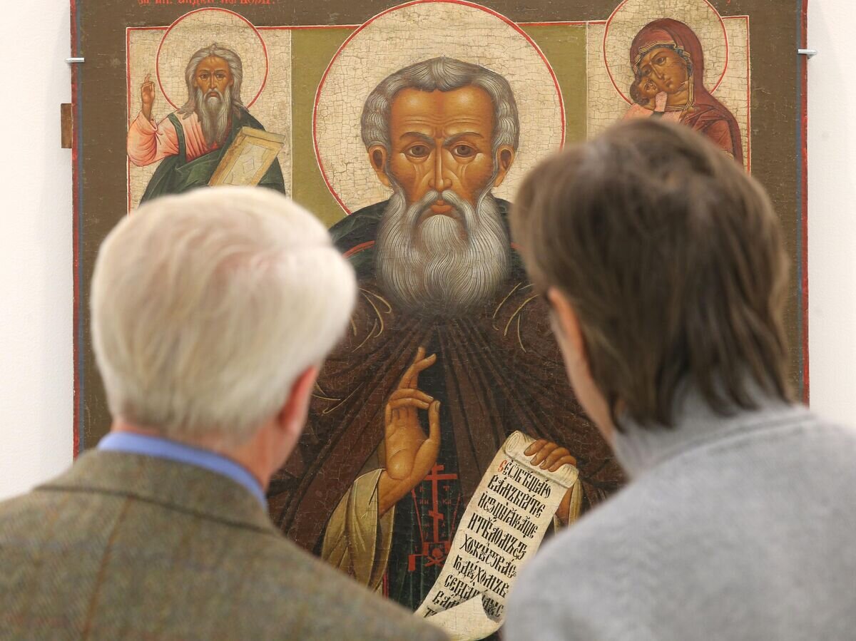    Посетители у иконы "Преподобный Кирилл Белозерский, с Андреем Первозваным, Богоматерью Владимирской, Чудом Георгия о змие и пророком Илией" (19 век)© РИА Новости / Виталий Белоусов