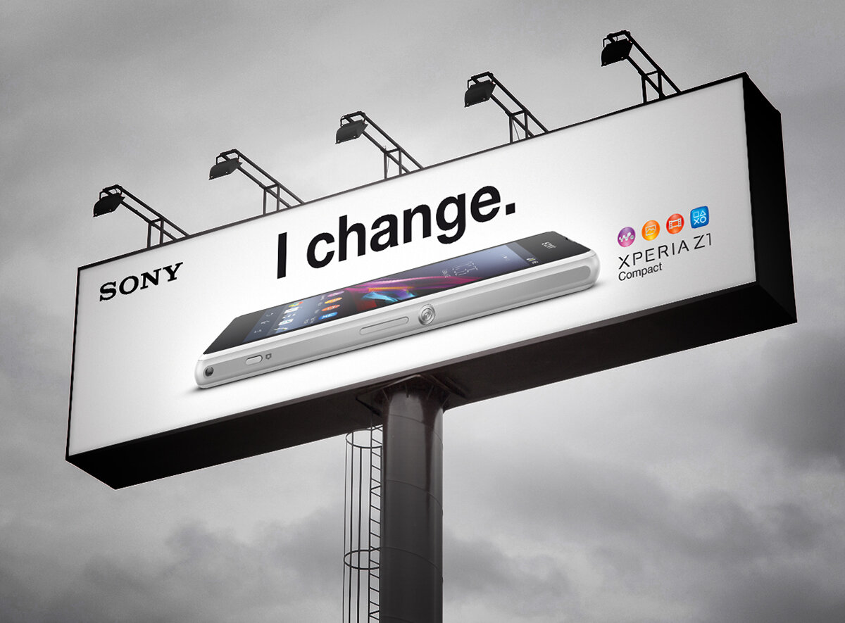 Рекламный щит Sony с изображением смартфона Xperia Z1 Compact и слоганом "I change" акцентирует внимание на способности устройства к адаптации и инновациям. 