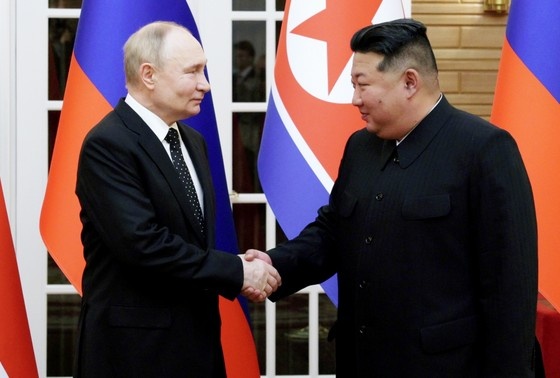    Президент РФ Владимир Путин и председатель государственных дел Корейской Народно-Демократической Республики Ким Чен Ын (справа) во время совместного фотографирования в Пхеньяне