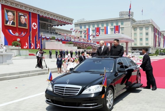    Президент РФ Владимир Путин и глава Корейской Народно-Демократической Республики Ким Чен Ын (на первом плане справа) во время церемонии официальной встречи на площади Ким Ир Сена в Пхеньяне