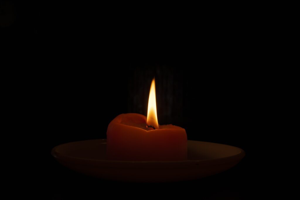    A closeup shot of a burning candle in the dark Екатерина Малаховская