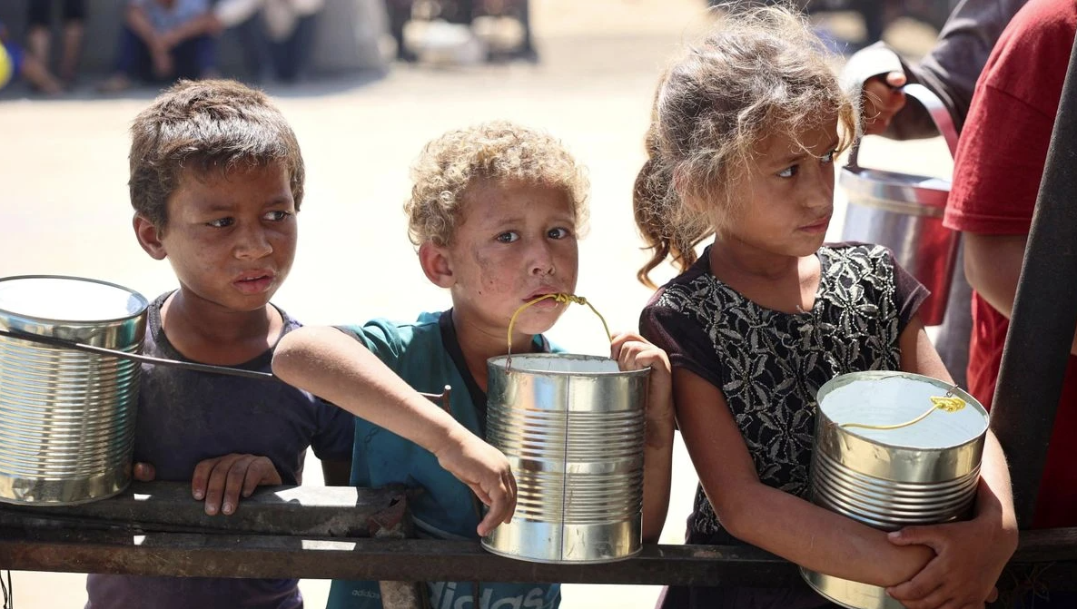 В Хан-Юнисе дети также стоят в очереди, чтобы получить несколько граммов муки или риса. © AFP via Getty Images | EYAD BABA