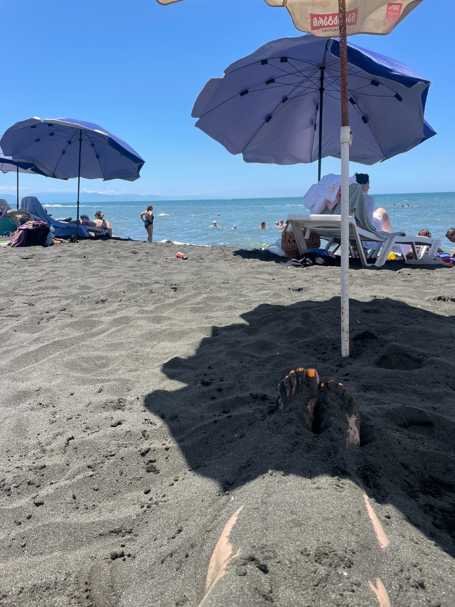 Доехали до Чёрного моря и сразу на пляж в Уреки. Там весь пляж чёрный - это целебный магнитный песок, в который рекомендуют закапываться не больше, чем на 15 минут в день.