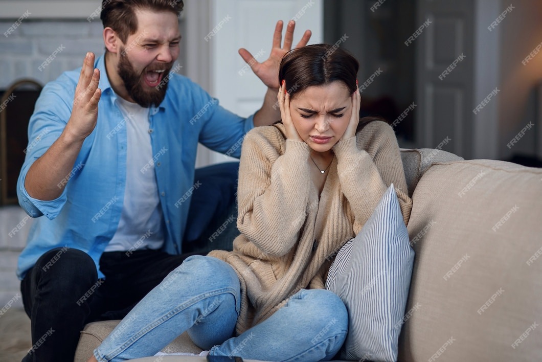 https://img.freepik.com/premium-photo/defenseless-upset-woman-closes-her-ears-while-her-husband-yelling-at-her-sitting-behind-family-relationship-problems-concept_141188-4556.jpg?w=1060