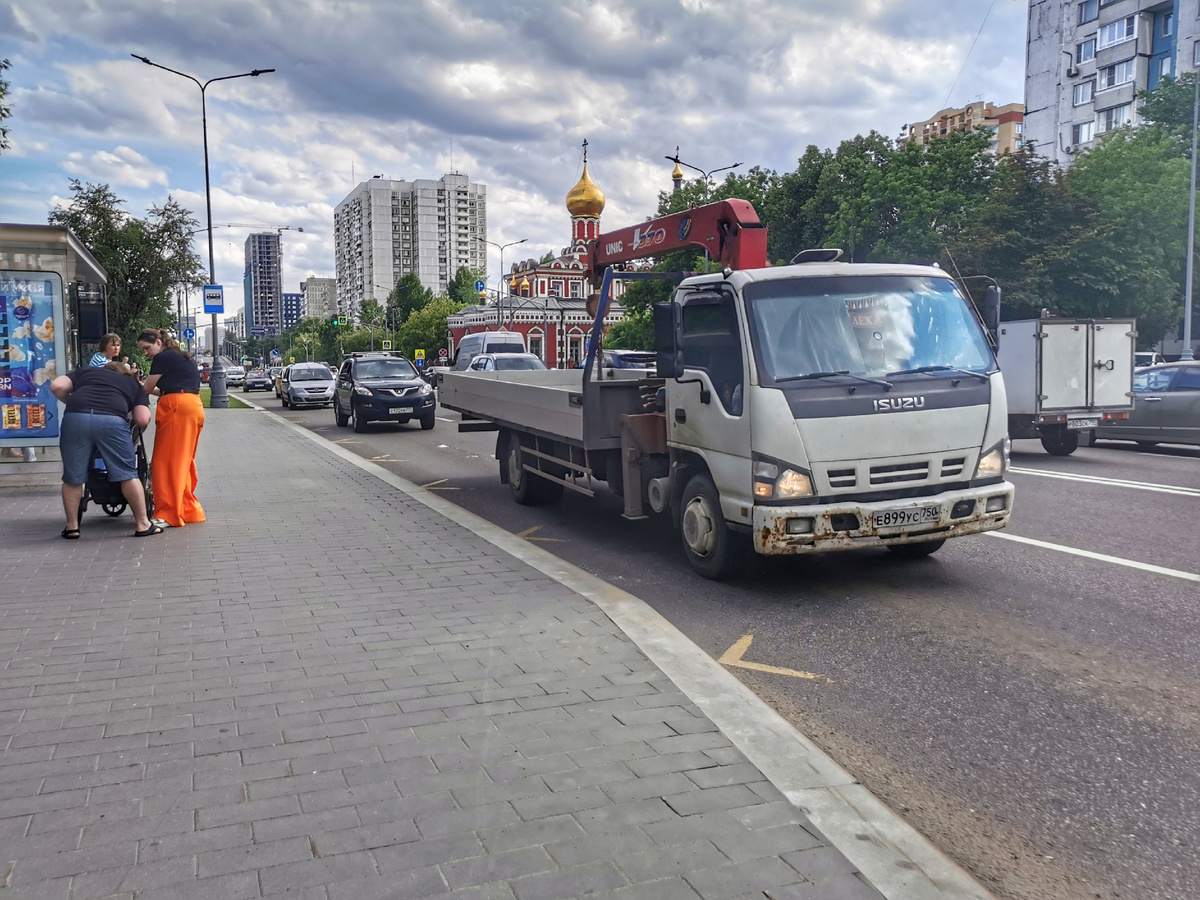 Грузовой автомобиль с манипулятором Isuzu-27999Е. Шереметьевская улица. Автомобиль этот выпускает ООО “Меткомплекс”. Стою на остановке, жду автобус в сторону Ботанической улицы.