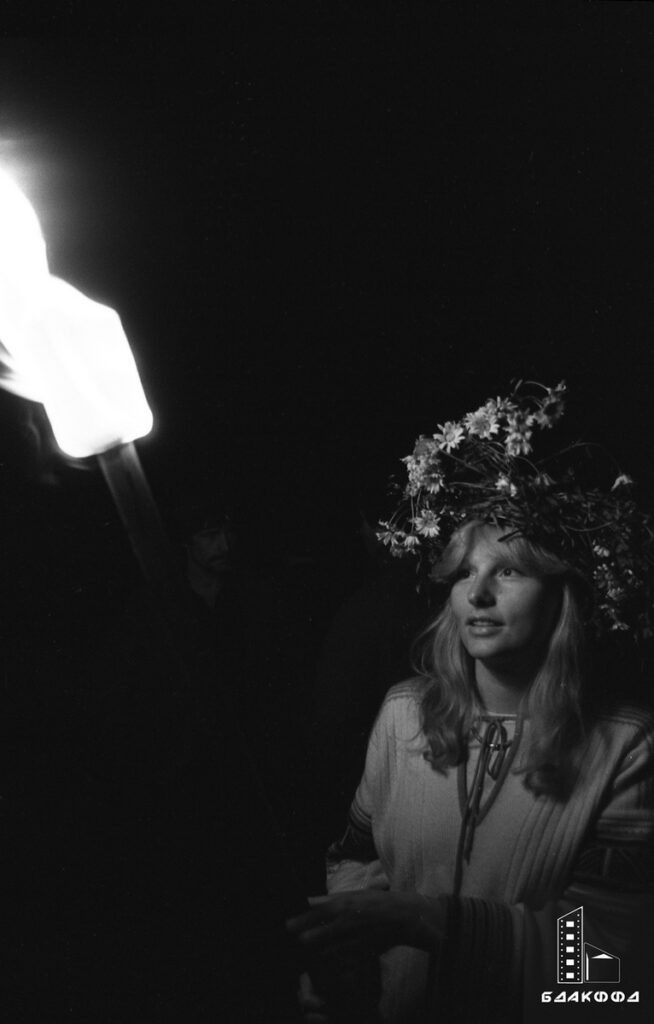 Купалье в Вязынке, Е.К. Козюля, Молодечненский район Минской области, июль 1982 г. С древних времен Купалье считался одним из самых «молодежных» праздников: на белорусском Полесье избирали самую красивую девушку и обряжали ее в гирлянды из цветов и трав: та с завязанными глазами раздавала избравшим ее заранее приготовленные венки, по которым гадали о будущем участников действа.