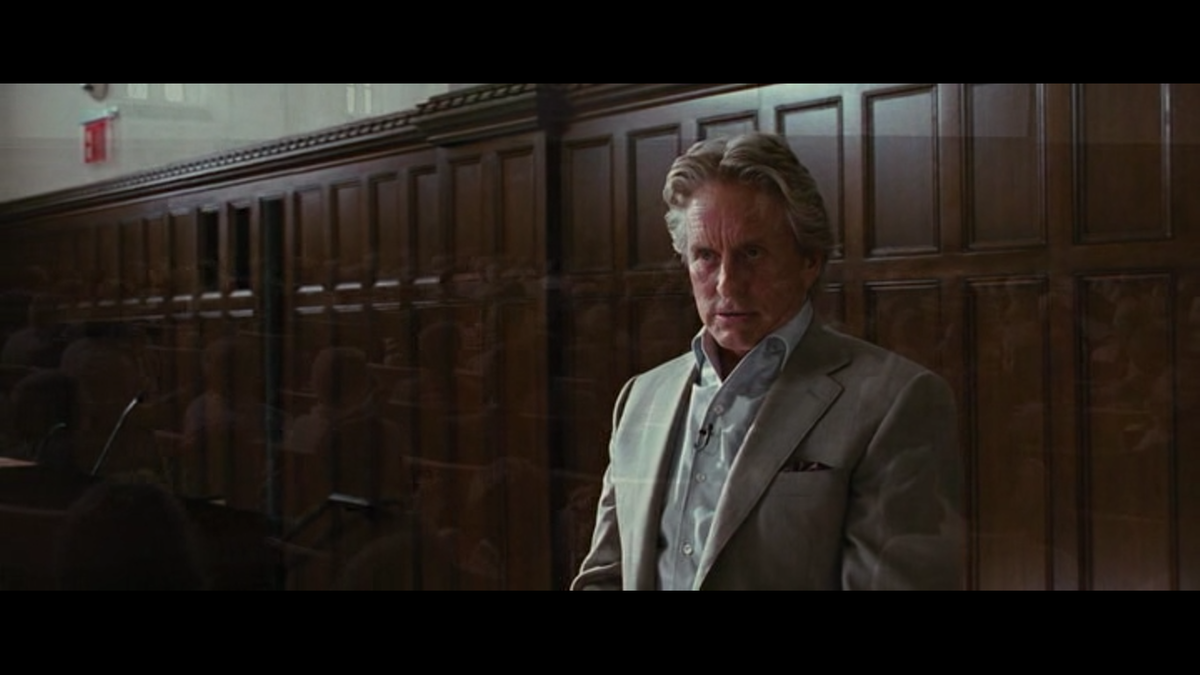 Гордон Гекко на лекции, где Джейк Мур впервые встречается с ним