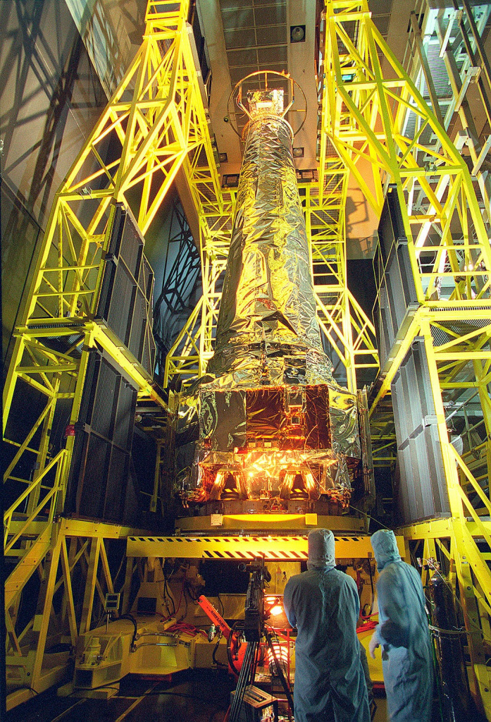    Технические специалисты на спутниковом объекте TRW в Редондо-Бич, Калифорния, осматривают рентгеновскую обсерваторию «Чандра» внутри испытательной камеры перед ее запуском в 1999 году.