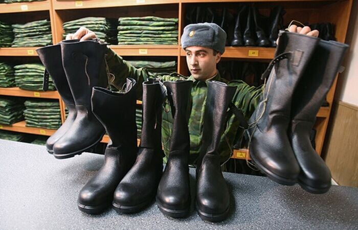 Солдат выдает кирзовые сапоги / Фото: 1001zaponka.ru