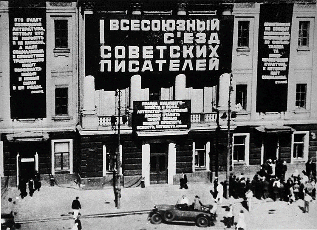I Всесоюзный след советских писателей, Москва, 1934 г. Посередине – цитата из М. Горького: «Правда будущего – проста и ясна. Литератор-пролетарий должен ставить своей целью именно простоту, ясность, четкость», а цитата из И. Сталина – справа: «Пролетарская по своему содержанию, национальная по форме, такова та общечеловеческая культура, к которой идет социализм», цитата же из В. Ленина сбоку, слева: «Это будет свободная литература, потому что не корысть и не карьера, а идея социализма и сочувствие трудящимся будут вербовать новые и новые силы в ее ряды». Источник: Яндекс картинки.