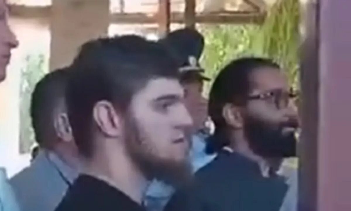 Слева - сорвавший крест мужчина, справа - батюшка. 