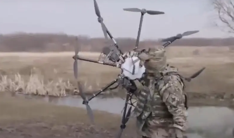 Российский военный со сбитым украинским дроном " Баба- Яга". ( Фото из открытых источников).