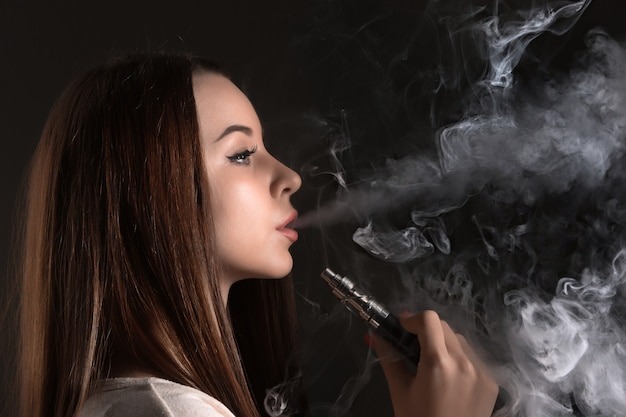 https://img.freepik.com/free-photo/face-vaping-young-woman-black-studio_155003-1831.jpg?uid=R80207095&ga=GA1.1.706223890.1717864400&semt=ais_hybrid