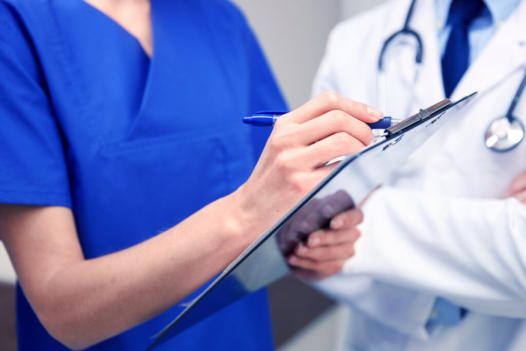    clinic, profession, people, healthcare and medicine concept - close up of doctors with clipboard at hospital Василий