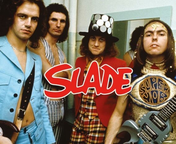 Группа Slade, слева направо - Jim Lea ~ бас-гитара, клавишные, скрипка, вокал, Don Powell ~ барабаны, Noddy Holder ~ лидер-вокал, гитара, Dave Hill ~ лидер-гитара, вокал 