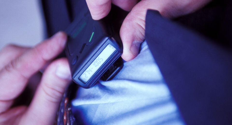    Man Checking his Pager / Global Look Press