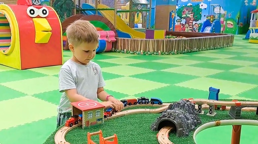 Child plays with ikea brio train rides on the railway