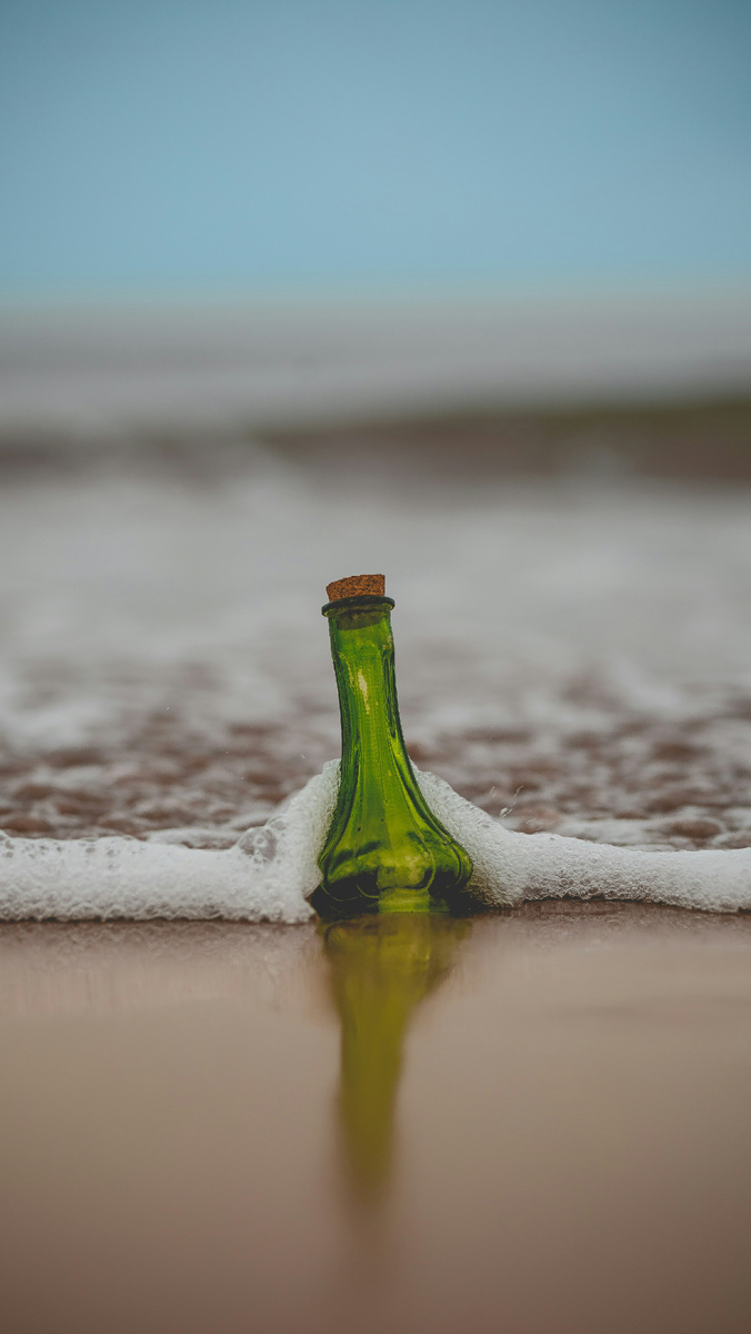 https://unsplash.com/photos/green-glass-bottle-with-cork-lid-on-shore-SZ80v2lmhSY