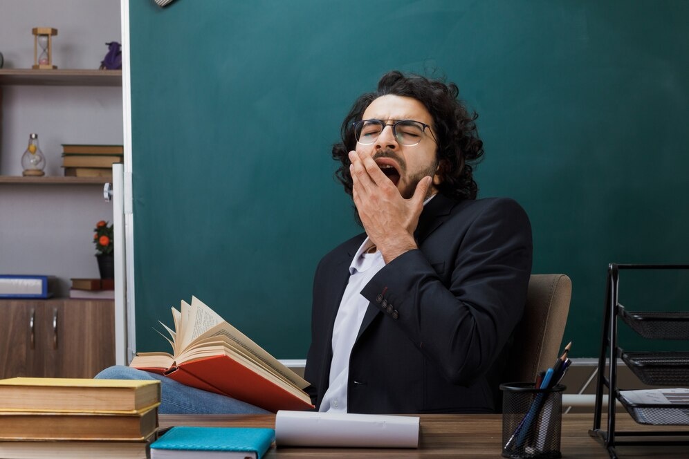 Адрес фото:https://img.freepik.com/free-photo/yawning-covered-mouth-with-hand-male-teacher-wearing-glasses-holding-book-sitting-table-with-school-tools-classroom_141793-114333.jpg?t=st=1727611143~exp=1727614743~hmac=f78fa86ef0aeb95a09eeca76a01d8854d150f78b904435128b196b96e1ad84d1&w=996