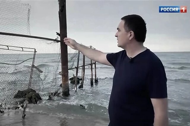    Николай Цомартов показывал на забор территории, куда забежала Аня. Фото: Кадр телеканала "Россия"