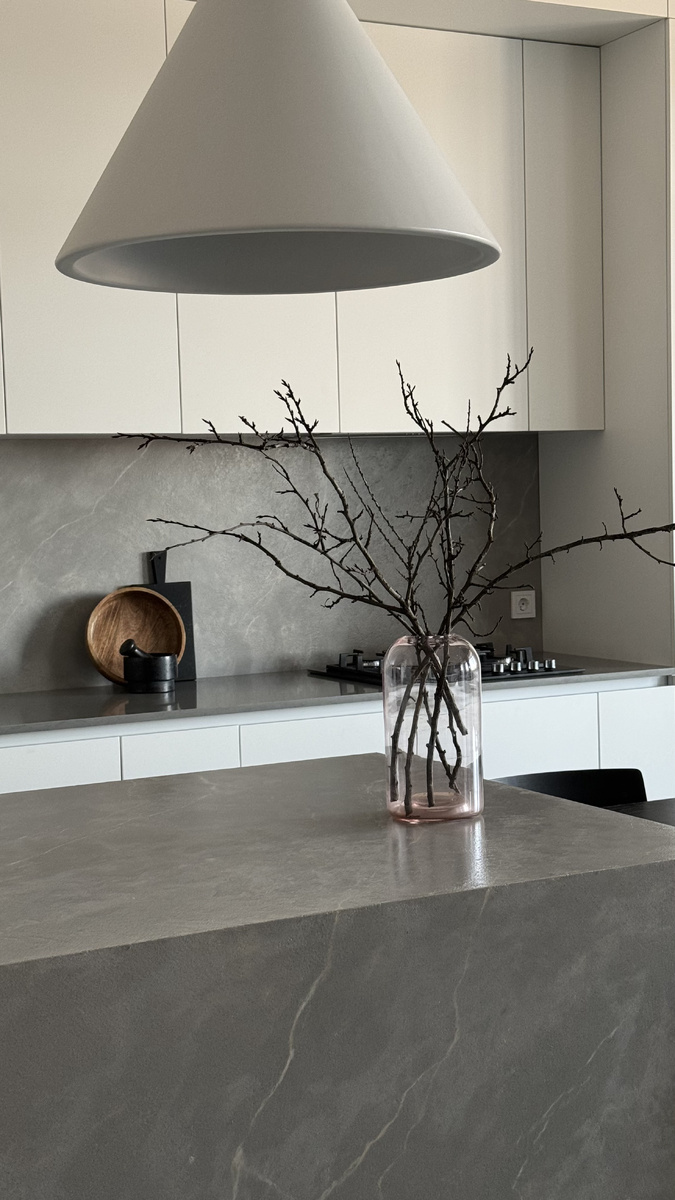 Имитация серого мрамора в отделке кухонного фартука и мебельной конструкции острова.