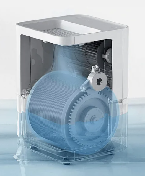 Увлажнитель состоит из бака с водой, барабана с дисками и вентилятора, который прогоняет воздух через барабан