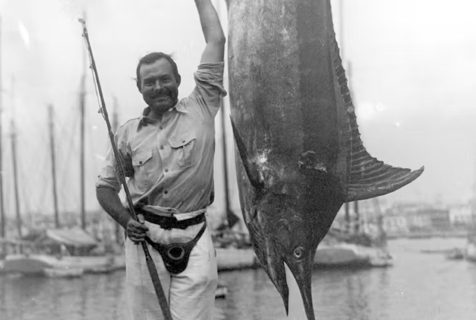Эрнест Хемингуэй был заядлым рыбаком. Здесь он позирует с марлином в гаванской бухте, Куба. Коллекция Эрнеста Хемингуэя. Президентская библиотека и музей Джона Ф. Кеннеди, Бостон.
