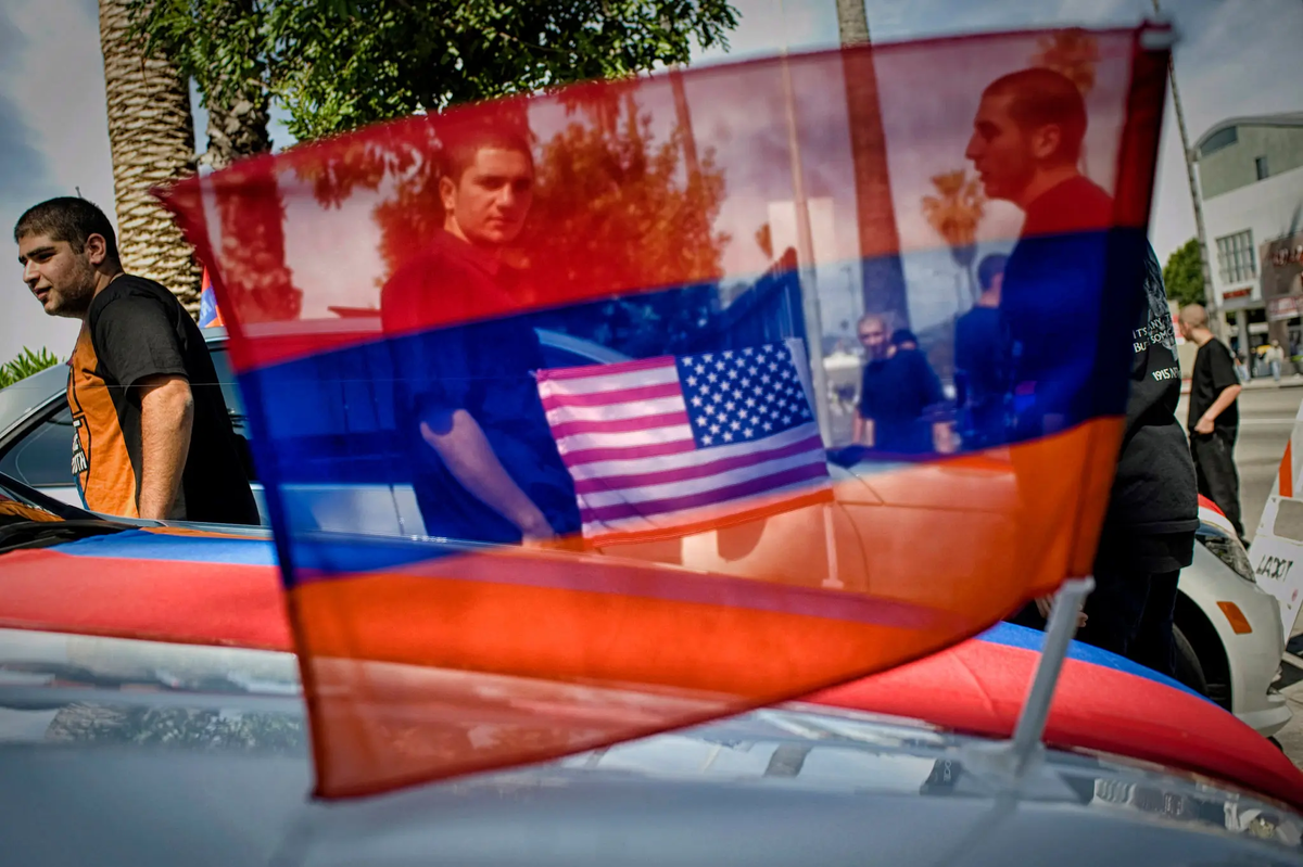 In a Los Angeles parking lot in 2012, young people awaited the start of a march commemorating the Armenian genocide.Credit...Scout Tufankjian/Polaris, from, There Is Only the Earth (Melcher Media) 