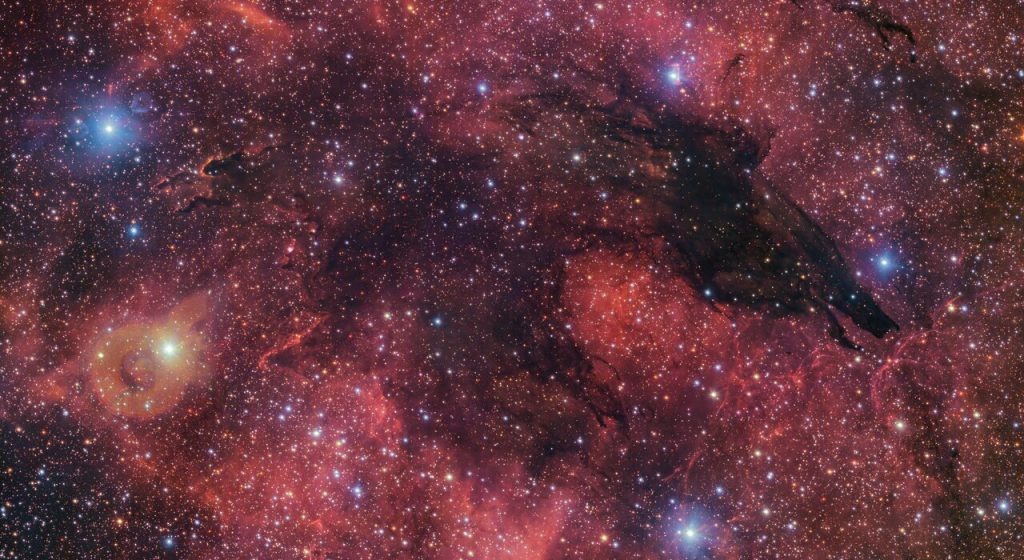    Fittingly nicknamed the Dark Wolf Nebula, this cosmic cloud was captured in a 283-million-pixel image by the VLT Survey Telescope (VST) at ESO’s Paranal Observatory in Chile. Located around 5300 light-years from Earth, the cold clouds of cosmic dust create the illusion of a wolf-like silhouette against a colourful backdrop of glowing gas clouds. Александр Шереметьев