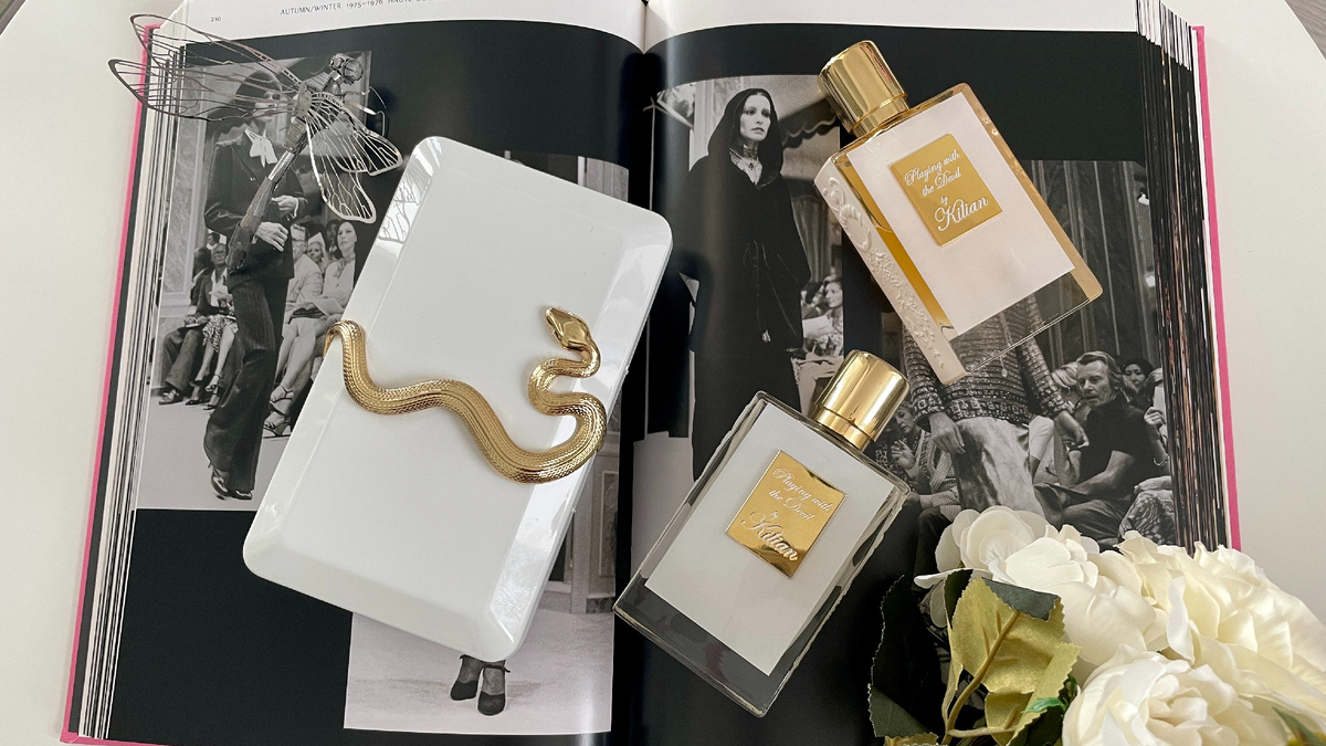 Playing With The Devil выпущен в 2013 году. Парфюмер: Calice Becker. Верхние ноты: Черная смородина, Белый персик, Личи и Красный апельсин; средние ноты: Красный перец, Перец, Роза и Жасмин; базовые ноты: Ваниль, Сандал, Пачули, Кедр, Бензоин и Бобы тонка