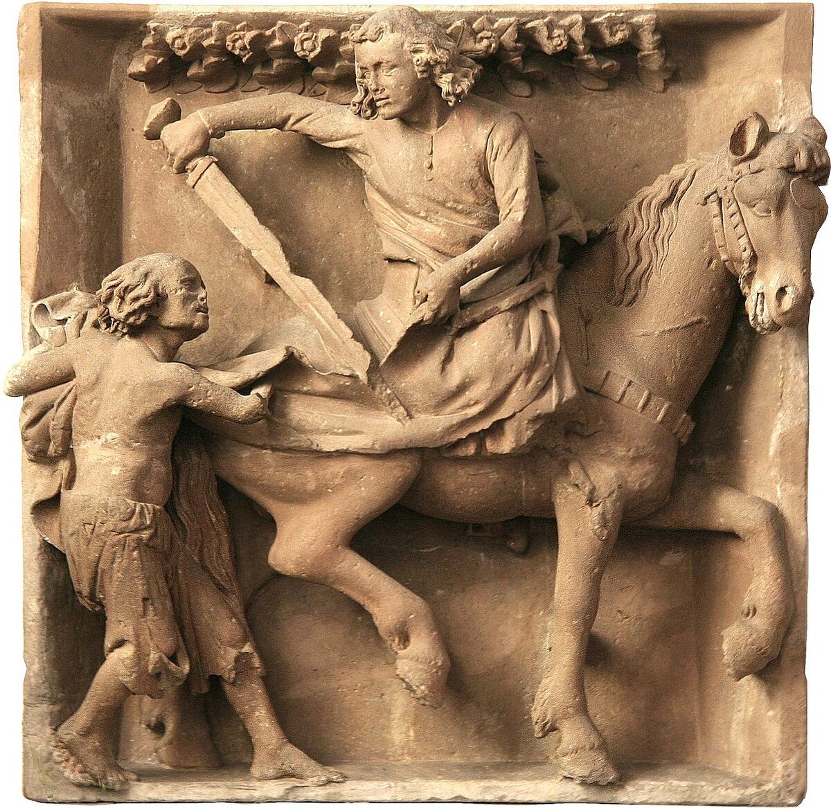 Самый популярный эпизод из жизни Мартина. Главное - верно понять изображённое скульптором событие: что святой мечом не просто так размахивает, а плащ режет! 