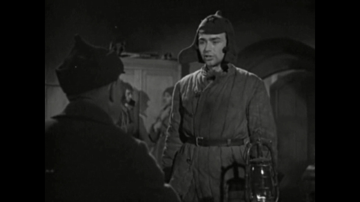 Соловьев в ватнике и буденновке у коменданта. Кадр из фильма