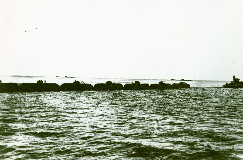 Центральный Музей железных дорог России. С.-Петербург предоставил мне фото схожей тематики: переправка цистерн через Ладожское озеро, 1942 г. Так же тянули и через Каспий.