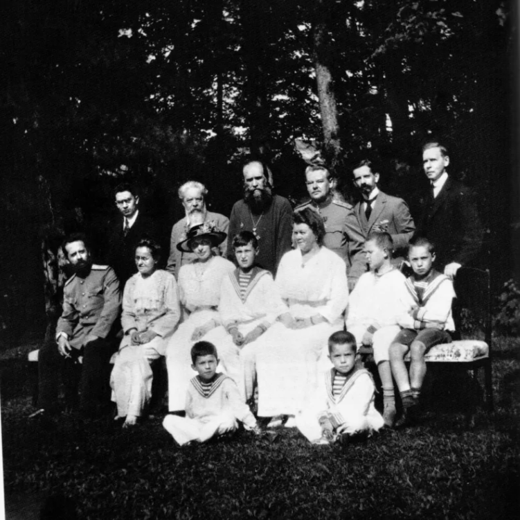 Слева направо стоят: лакей Журавский, Терентий Иванович Чемодуров, Васильев, Петров, Пьер Жильяр, Чарльз Сидни Гиббс. Вторая линия: Владимир Деревенко, Елизавета Эрсберг, Александра Теглева, царевич Алексей Николаевич, Мария Густавна Тутельберг, Коля Деревенко, Алексей Деревенко, Александр Деревенко и Сергей Деревенко; Царское Село, 1916 год.