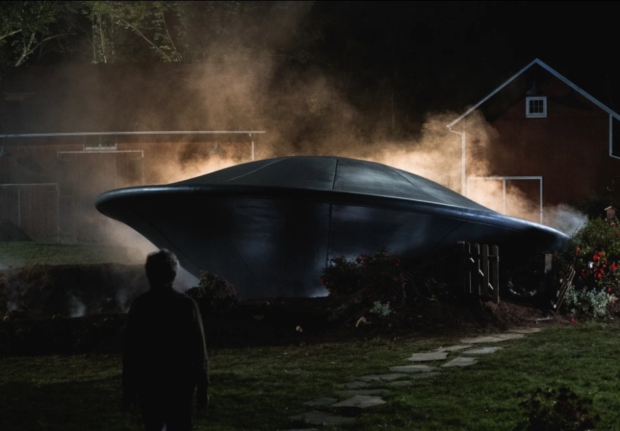 Тарелка в саду, помявшая красивые заросли азалий.