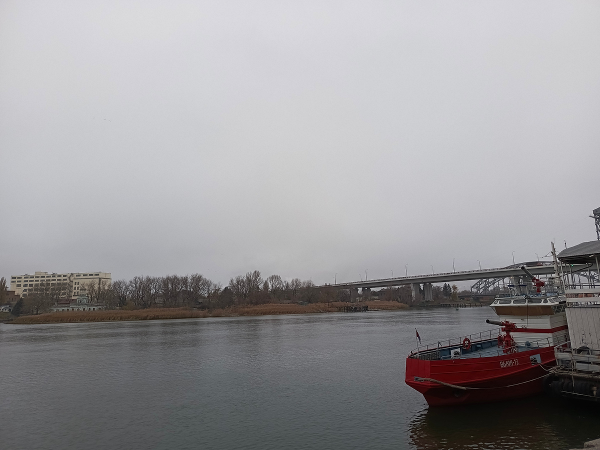 Красный катер - яркая деталь на сером фоне