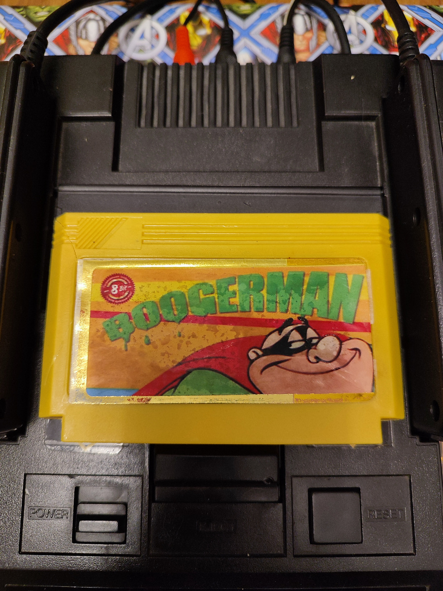 Фото сделаны мной. На фото игра "Бугермен". Оригинал игры  "Boogerman: A Pick and Flick Adventure" был разработан Interplay Productions, Inc. и издан Interplay в 1994,.г. для платформ Sega Mega Drive, Genesis, SNES. Геймдизайнеры Кристофер Треммел, Майкл Стрэг. Фото демонстрирует начальную заставку игры, а так же общий визуальный фон игры. Подробнее об этом рассказано в статье. Все материалы принадлежат правообладателям и размещены исключительно в информационных целях.